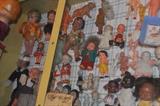 Miscellaneous bisque figurines, celluloid and early plastic dolls in a Mother's Cookie display