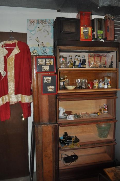 Vintage Santa suit to your left, a couple of barristers/lawyers cases on their sides, and 5 stacks of cases to the right.  This photo is a couple of weeks old (it's really full now) but there are some bisque bath salt figures as well as a great collection of advertising pieces.