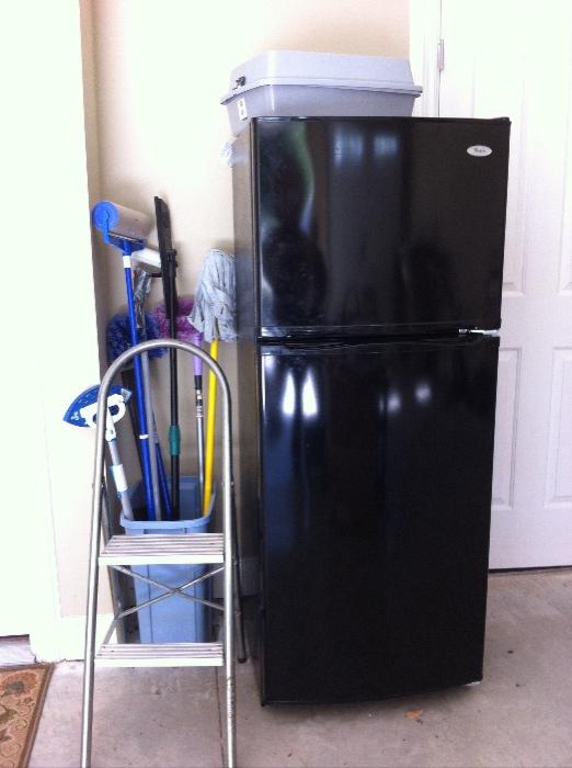 Apartment size refrigerator/freezer, assorted garage items.