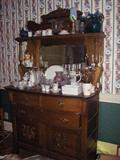 Carved antique display chest chock full of glassware and china