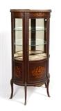 Lot 1020: R. J. HORNER MARQUETRY INLAID SERPENTINE VITRINE: Pierced brass gallery over embossed metal swag trim, serpentine front case with foliate scroll and floral motif inlay. Mirrored back interior with 2 glass shelves, velvet lined shelf. All on 4 shaped legs with ormolu accents. R. J. Horner celluloid tag on back. Overall measures 55'' h. x 27'' x 13 3/4''.
CONDITION: Wear consistent with age and use. 