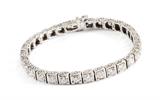 Lot 1041:  8 CTW DIAMOND LINE BRACELET:  Each of the 31 round brilliant diamonds set in 14K white gold.  Diamonds total approx. 8.00 Ct., averaging SI1-SI2 in clarity and H-I color.  Locking closure with hidden hinged safety clasp.  Length 6.5".  Weight 18.6 grams.  Sold with current Florida Diamond Appraisers GIA graduates appraisal for $20,850.  