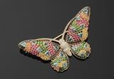 Lot 1051:  ELI FREI MULTI COLOR GEM STONE BUTTERFLY PIN: Brilliant diamonds totaling 1.15 Ct and rubies, sapphires, tsavorite and blue topaz totaling 6.08 Ct. TOTAL gem weight 7.23 Ct. Mounted in 14K yellow gold. Eli Frei, 5th Ave. NYC. Signed ''Frei 18K''. Wing span 2.25''. Weight 12.5 grams. Est. $5000/9000**