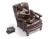 Lot 1194:  ONDER, J.A., (Canadian-American, 20th Century): ''Puppy Dog Tales'', Depicts a Young Child in an Oversized Chair Reading a Book to a Puppy Dog in His Lap, Patinated Bronze, 12 1/2'' h., two part bronze, 12'' w. x 8'' w., incised signature dated 2002, #'d 9/42. Est. $1000/2000**