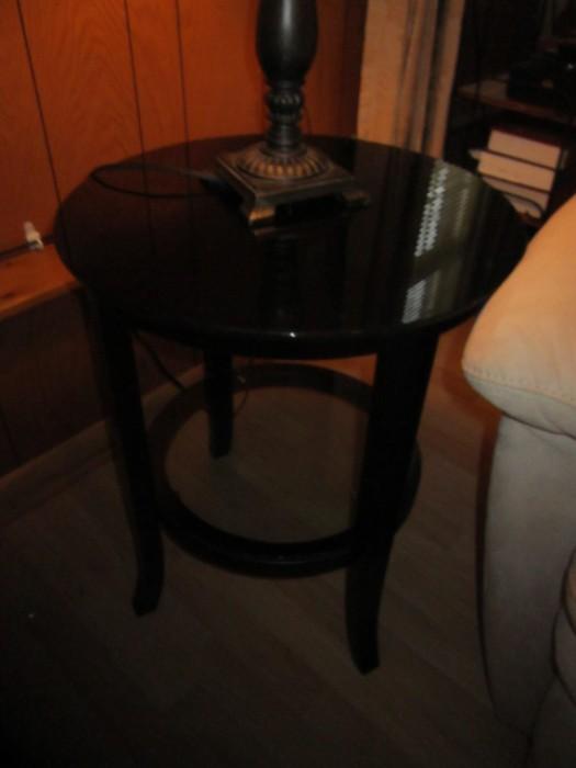 One of a pair of end tables with glass tops and bottom shelves