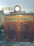 beautiful cabinet with two old clocks