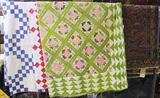 Wide-Angle Photo of Sarouk Oriental Rug & 2 Patchwork Quilts.