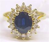 14KT DIAMOND RING W/LARGE OVAL SAPPHIRE CENTER.