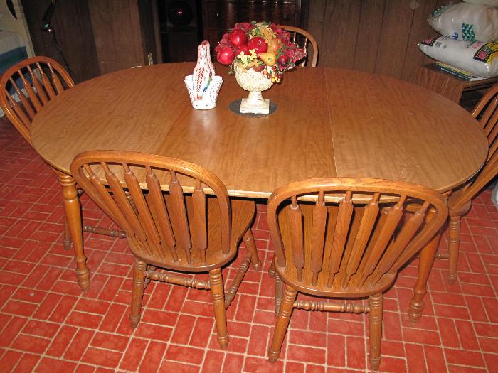 Oak dining set with six arrowback chairs.