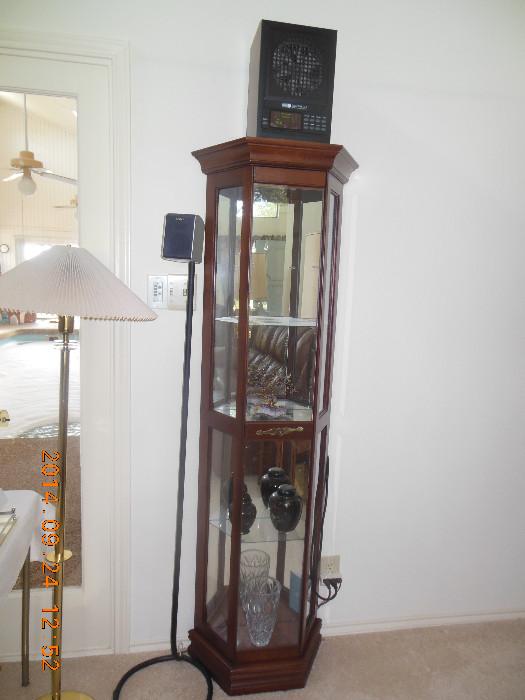 We have 2 floor standing , glass shelves, lighted wood curio cabinet.