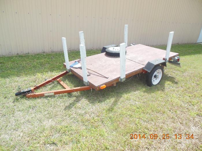 About a 8' tantem axle flat bed trailer, with a extra tire.    Price At:  $325.00