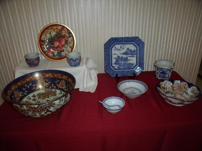 Large Chinese bowl to left, Chinese rice grain bowls and spoon and older bowl to right.