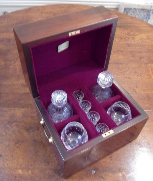 Cased cut glass decanters with mixers and drinking glasses.
