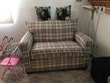 This cute little love seat is actually a sofa bed too!