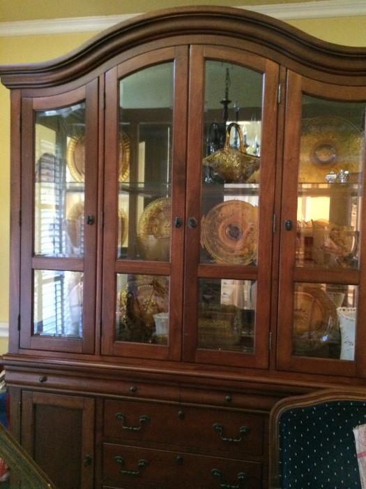 china cabinet containing amber tiara glass