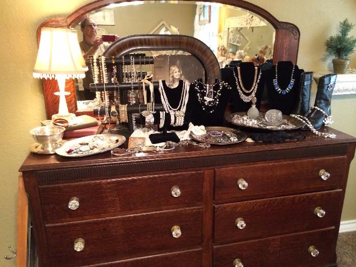 oak dressing table with mirror, costume jewelry, vintage lamp, frames