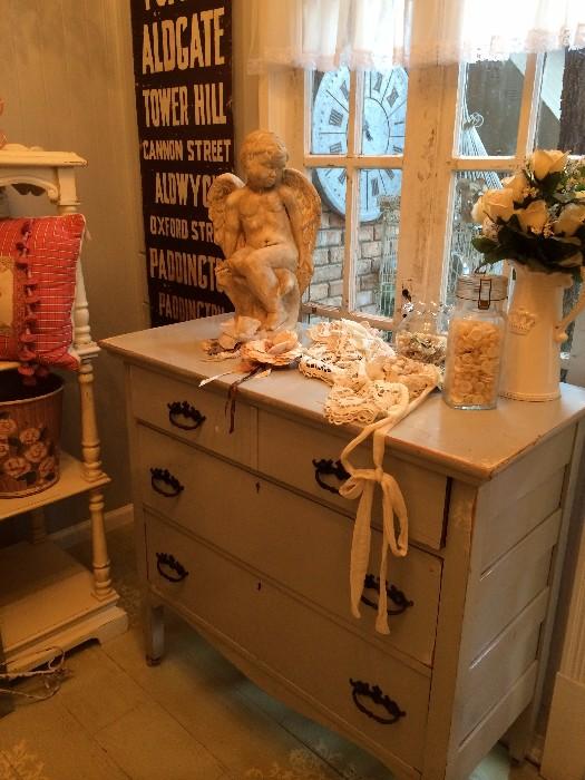 painted chest of drawers, statue, vintage linen pieces