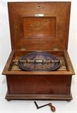 Lot#2083, MONOPOL, GERMAN WALNUT DISC MUSIC BOX, C. 1900, H 11", W 20 1/2", D 16 1/2", DOUBLE COMB.With a crank and 38 13 1/2" metal discs.