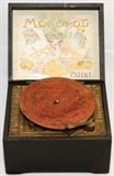 Lot#2084, MONOPOL, GERMAN PAINTED WOOD DISC MUSIC BOX, C. 1900, H 4 1/2", W 7 1/2"Painted black wood hinged case opens to lithographed interior cover.  With crank and ten 5 3/4" discs.