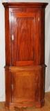 Lot#2096, SOUTH AFRICAN CORNER CABINET, 19TH.C., H 6' 8", W 2' 8"In two parts. Raised on short legs with scalloped skirt, shaped cornice. Panel doors. From the collection of Irene Walt, Huntington Woods, Michigan.