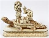 Lot#2209, CHINESE CARVED BONE SCULPTURE H 16.5", L 20.5", TWO MEN RIDING A TURTLE.The Chinese carved bone, panel assembled, sculpture depicts two men riding a giant turtle with four smaller turtles.