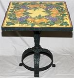 Lot#2316, WROUGHT IRON AND TILE TABLE CIRCA 1910 H 26" W 24"Square table having nine tiles set in surface. Wrought iron pedestal base. From the collection of Irene Walt, Huntington Woods, Michigan.