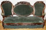 Lot#2321, VICTORIAN HAND CARVED SOFA, H 39.5", L 71"Beautifully hand carved frame in high relief depicting birds, grapes and leaves.  Caved grapes on legs and leaves on the apron.  Green velvet upholstery and green fringe from the apron to the floor.