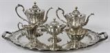 Lot#1004, DURGIN STERLING TEA & COFFEE SET WITH TRAY, EARLY 20TH C., SIX PIECES, PATTERN #1822.Sterling silver set includes 1 teapot, H.8 12", 1 coffee pot, H.10 1/2", 1 creamer, H.7", 1 covered sugar bowl, W.10", 1 waste bowl, W.6", and 1 serving tray flanked by handles, L.30"; each piece is engraved with a three-letter LCH monogram, stamped manufacturer's mark at the underside, and retailed by Grainger, Hannan, Kay & Co. (see additional photos).  Totaling approximately 223.7 troy oz.