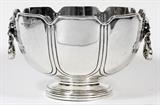 Lot#1008, GEORGE V STERLING BOWL BY LIONEL A. CRICHTON, LONDON, 1914-15, H 5", DIA 8"Sterling silver bowl in the form of a monteith, or punch bowl, with a notched rim and paneled sides, flanked by lion's mask and scroll handles, raised on a circular foot.  Hallmarks include a lion passant, uncrowned leopard, date letter "t", and maker's mark "LAC" for Lionel Alfred Crichton (see additional photo), stamped underneath as well, "Crichton Bros., New York & London, 12201" (see photo).  Measuring H.5 1/4" x 8 1/4", and weighs approximately 25.72 troy oz.
