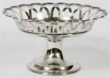 Lot#1011, WHITING MFG. CO. STERLING COMPOTE, 1910, H 5 1/2", DIA 9 3/4"A round sterling silver compote with a scalloped rim and pierced sides, stamped manufacturer's mark underneath along with the date mark for 1910 and number 135.  Weighs approximately 23.1 troy oz.