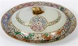 Lot#1073, CHINESE EXPORT PORCELAIN OVAL PLATTER WITH COVER & DRAIN, 18TH C., L 17" X 14"Including an oval platter, H.2 1/2" x 17 1/4" x 14 1/2", with a pierced, removable drain, 13" x 10", and a domed cover, L.14" x 11 1/2"; each piece is hand decorated with multiple pairs of dragons flanking a sphere, in shades of green, orange, periwinkle, lavender, yellow and pink with gold accents.  The cover is centered by a pinecone finial.