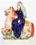 Lot#1102, ENGLISH STAFFORDSHIRE FIGURE, 19TH C., H 12", EMPRESS OF FRANCE.Measuring 12" x 9 1/2". Circa 1860.