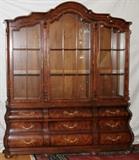 Lot#1170, HENREDON MAHOGANY CHINA CABINET, H 85", W 72", D 16"The lower section has six drawers and the top section has three glass doors which reveal glass shelving.  Electrified.
