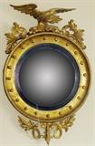 Lot#1198, AMERICAN FEDERAL BULL'S-EYE MIRROR WITH EAGLE CREST, EARLY 19TH C., 32" X 21"With 20 balls about the convex glass, gold leaf decoration.