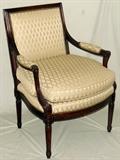 Lot#1314, LOUIS XVI STYLE WALNUT ARMCHAIR, EARLY-MID 20TH C.Hand-carved walnut frame, upholstered back and seat cushion flanked by padded open arms.