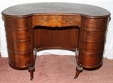 Lot#1318, MAHOGANY KIDNEY-SHAPE DESK, C. 1940.A single drawer at the center, swing-out drawers at each side.