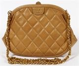 Lot#1488, CHANEL QUILTED TAN LEATHER SHOULDER BAG, W 10"Quilted tan leather shoulder bag, hinge clasp opening to a leather lined interior, with a single zippered pocket at one side, labeled: Chanel, Made in Italy. Includes the Carte D'Authenticite card, #0437159, which matches the hologram tag at the interior. Measures W. 10" x 7", L. 18 3/8" to the chain-link and leather shoulder strap.