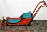 Lot#1537, ANTIQUE PAINTED WOOD CHILD'S SLED, H 32", L 54"Painted red and black, with metal supports and covering the runners.