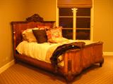 Antique burled bed that has been converted to a queen size.