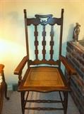 Unusual high back oak arm chair with caned seat.
