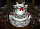 16 place settings (80 pieces) Gibson poinsettia and holly dinnerware. 14 matching tumblers.