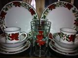 16 place settings (80 pieces) Gibson poinsettia and holly dinnerware. 14 matching tumblers.