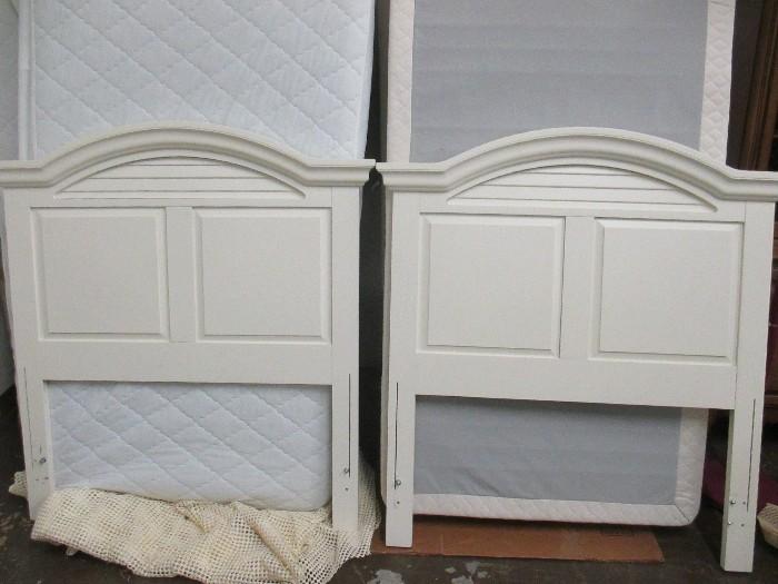 Cottage style white headboards and complete twin beds