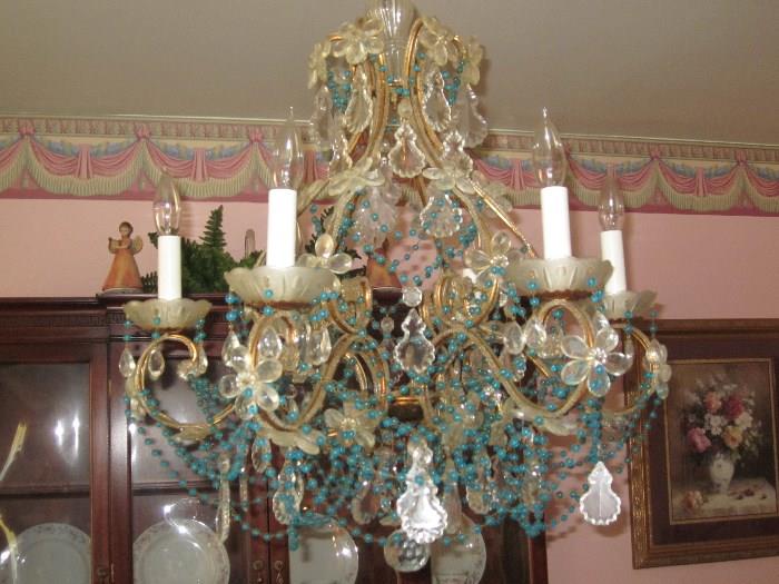 6 arm crystal chandelier accented with rosettes & blue crystals