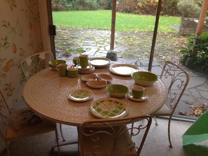 Woodard chairs and a mosaic tiled table top.  Vintage set of stoneware for 7 with serving pieces.