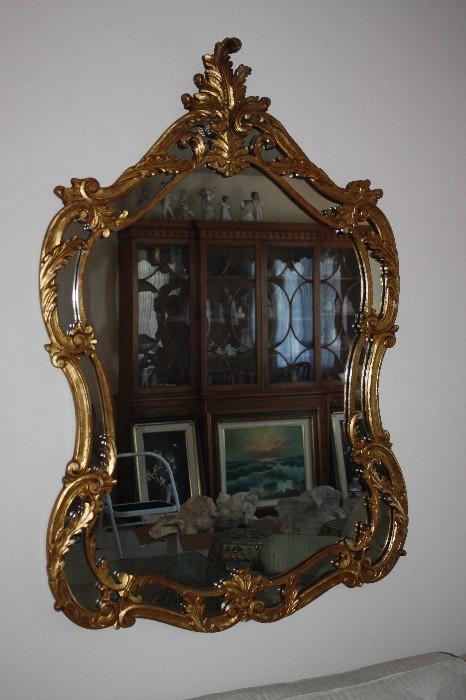 Ornate Baroque Mirror - Hollywood Regency - Italian Carved wood and gilded- in reflection id the Baker Display cabinet a few of the Lladro Angels