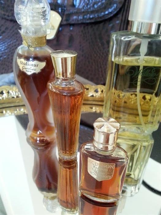 Vintage Shalimar, a women’s fragrance originally created by Jacques Guerlain in 1921 as a classic soft amber (Oriental) parfum, and currently produced by Guerlain. in glass bottle. Vintage bottle of Écusson  by Jean d'Albret. Handled mirrored dressing tray. 