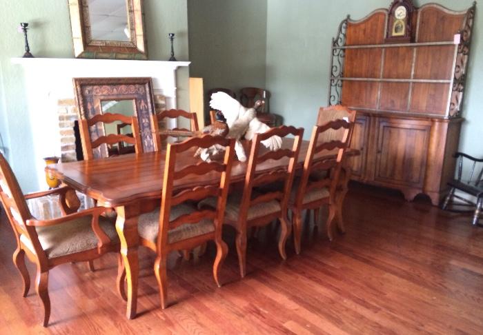 Lovely table with 8 chairs and matching hutch. Just in time for the holidays! Shown with one leaf, but there are two!