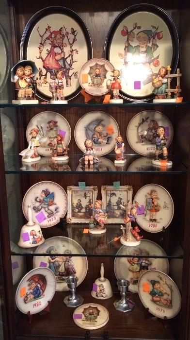Lots of Hummel figurines, plates, art, bells, and trays.