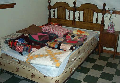 Bed, quilts and smoking stand